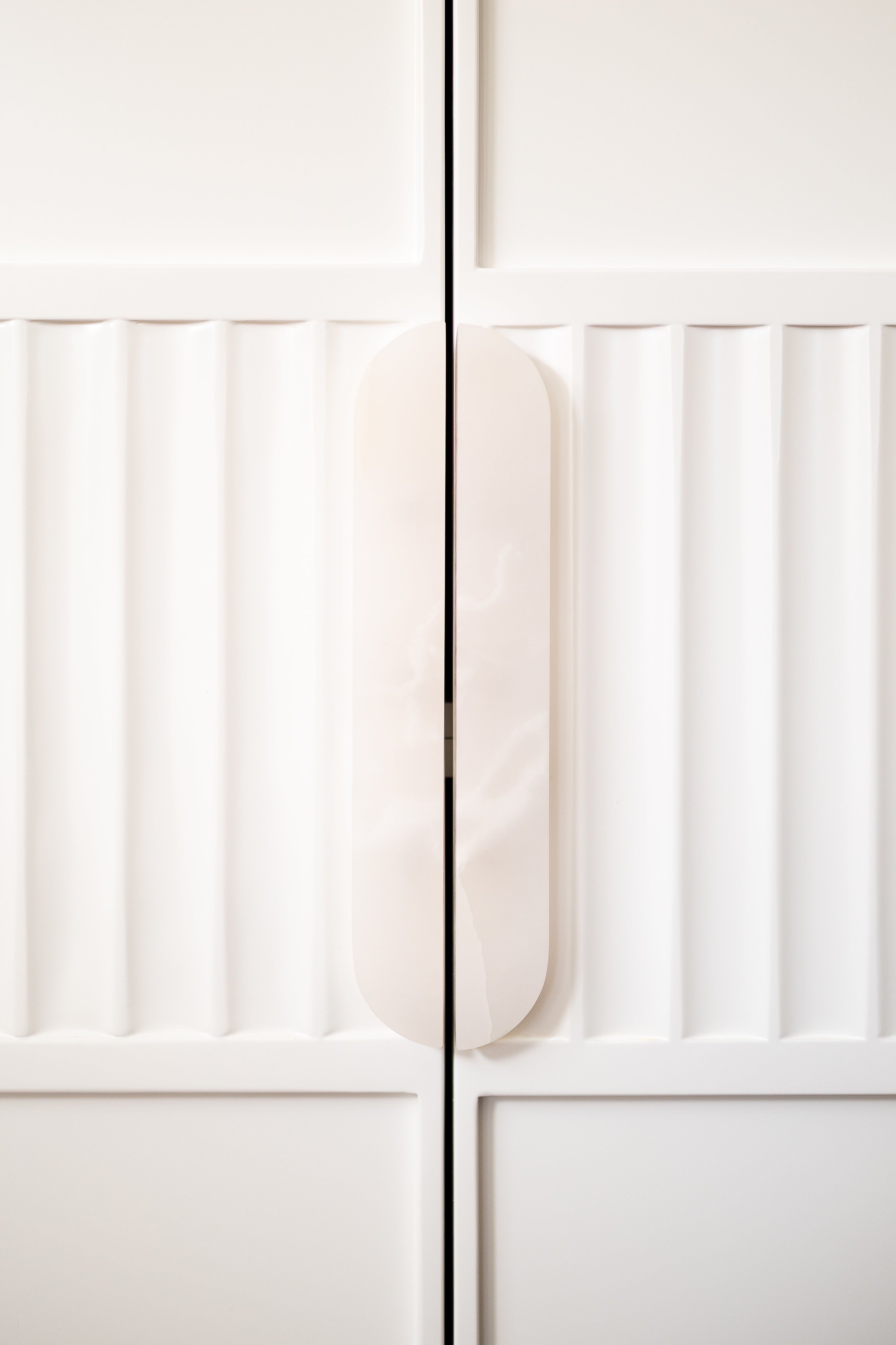Earlwood kitchen — White Onyx cabinet pulls on fluted cabinetry